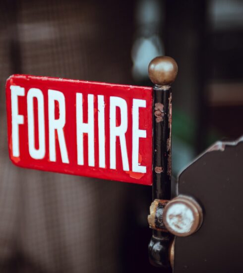 shallow focus photography of red and white for hire signage