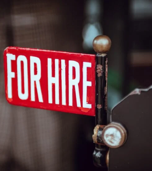shallow focus photography of red and white for hire signage