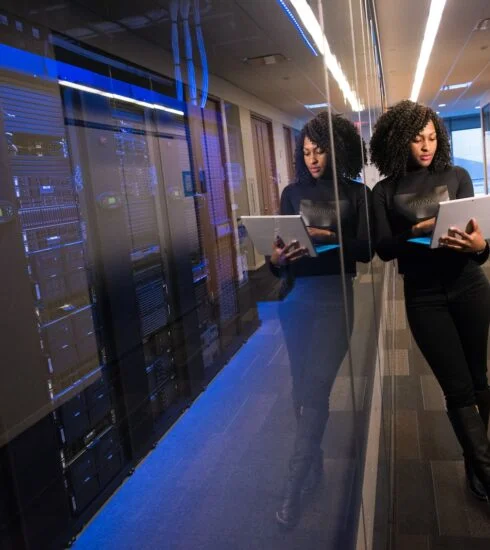 woman in black top using Surface laptop